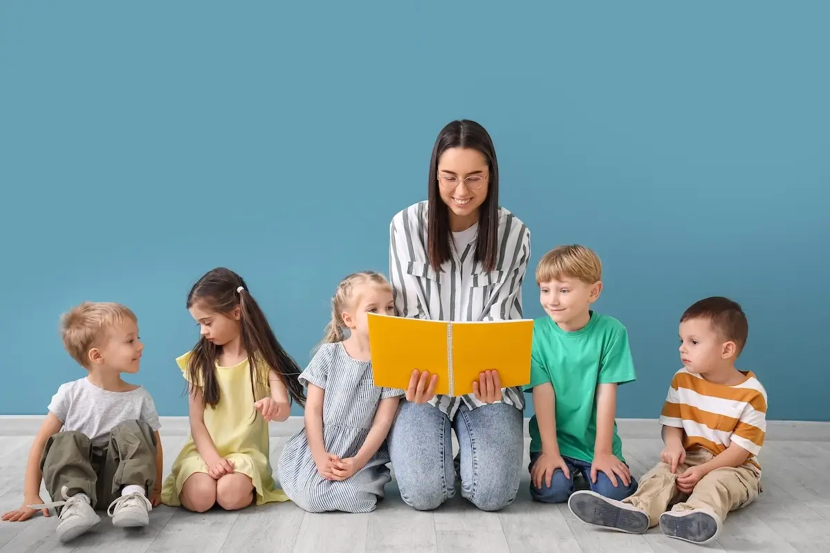 A teacher reading a book to students