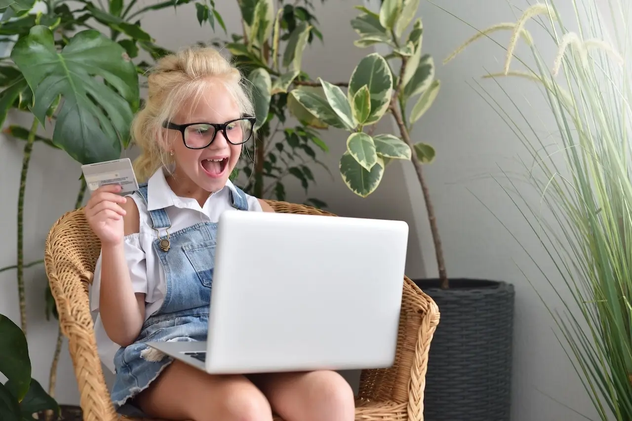 Child with laptop and credit card