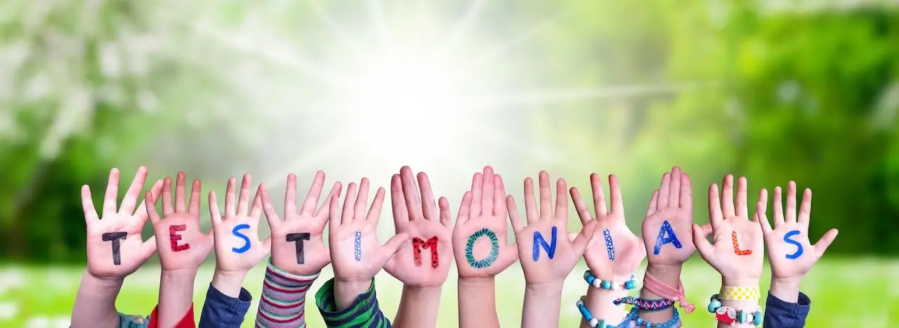 Children's hands spelling out the word Testimonials